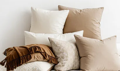 Neutral cushions and a woven throw